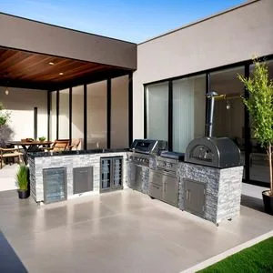 Custom L-Shaped Outdoor BBQ Island Made of Natural Stone, Featuring Grill Wine Cabinet and Refrigerator